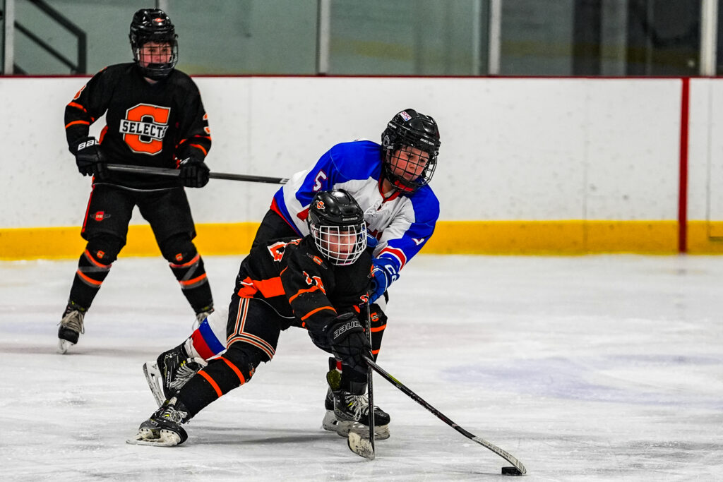 Two athletes skating with helmet