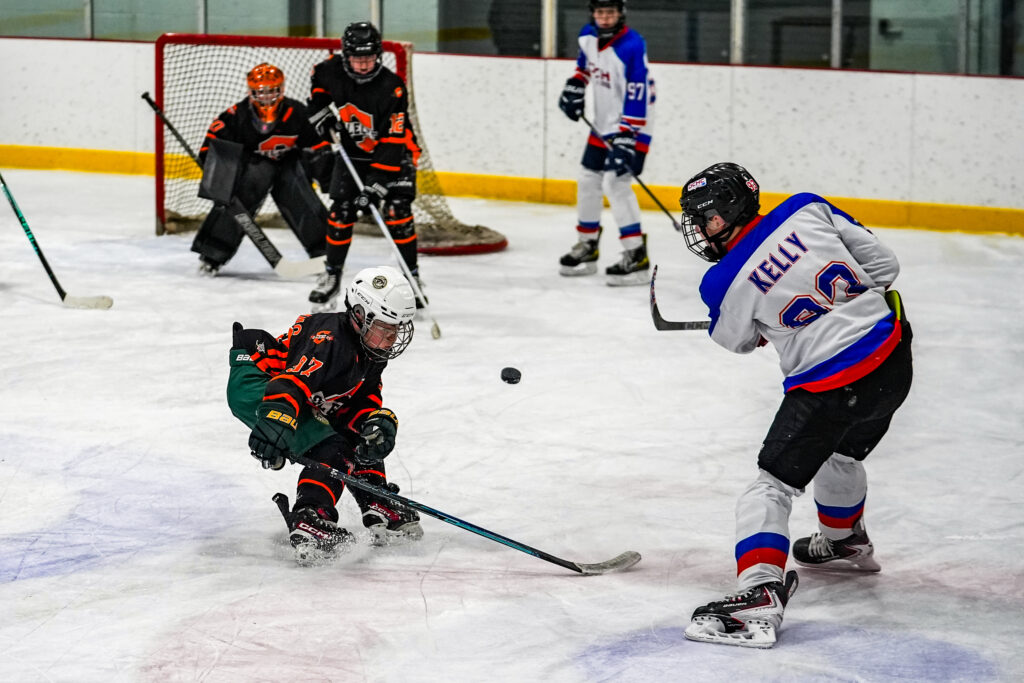 A group of athletes skating with helmet on the rink