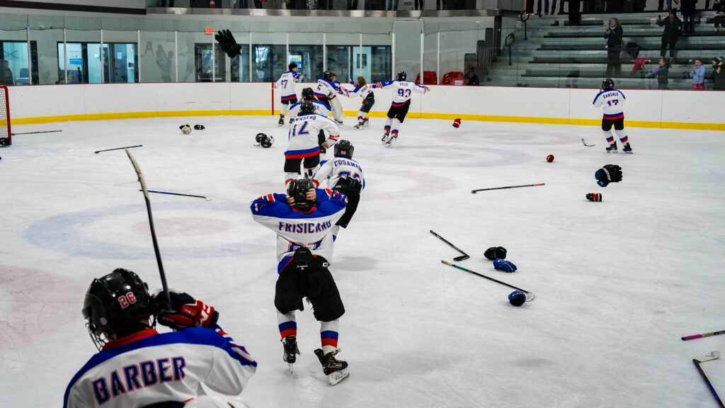 A group of athletes skating with ball and helmet on the rink