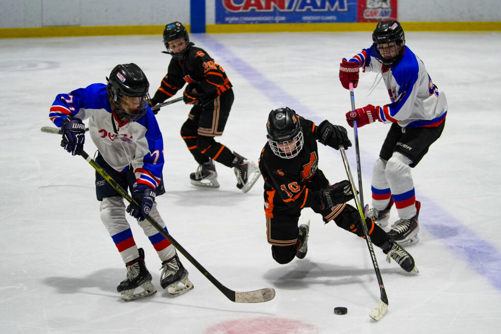 A group of athletes skating with helmet on the rink