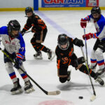 A group of athletes skating with helmet on the rink