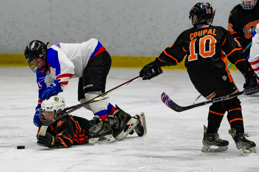 A group of athletes skating with helmet on the rink