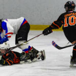 A group of athletes skating with helmet on the rink