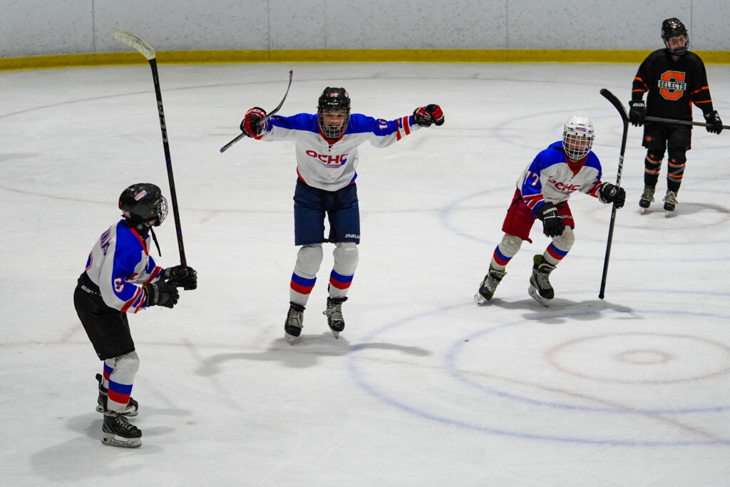 A group of athletes skating with helmet on the rink
