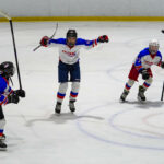 A group of athletes skating with helmet on the rink