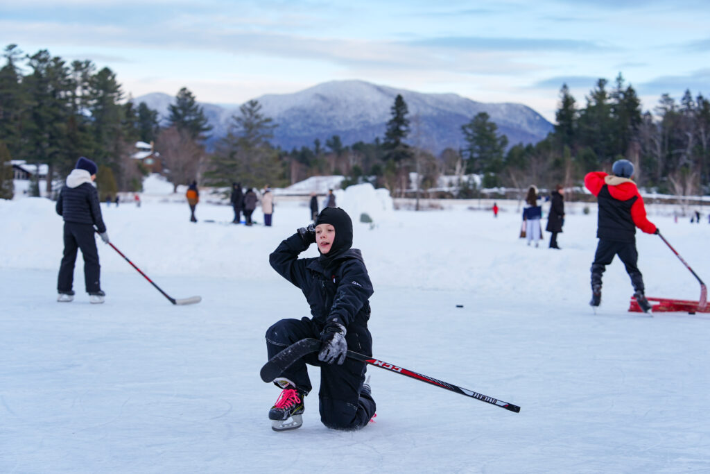 A group of athletes skating with helmet on the rink