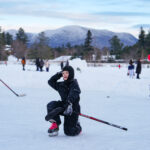 A group of athletes skating with helmet on the rink