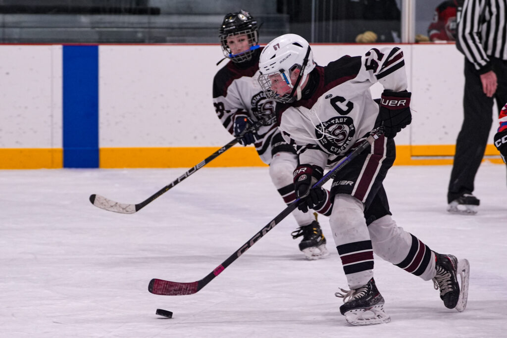 A group of athletes skating with helmet on the rink