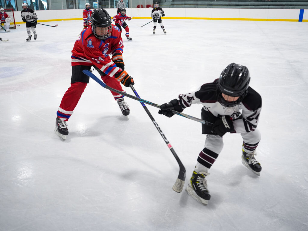 A group of athletes skating with helmet on the rink