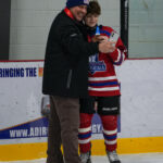 Two athletes skating on the rink