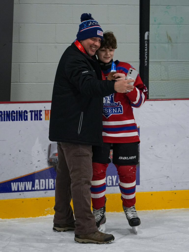 Two athletes skating on the rink