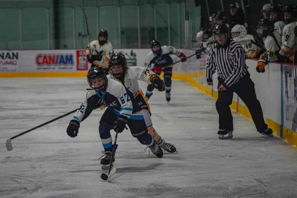 A group of athletes skating with helmet on the rink