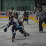 A group of athletes skating with helmet on the rink