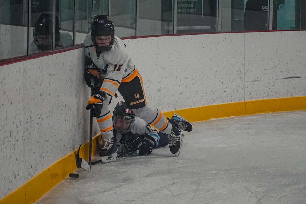 An athlete skating with helmet on the rink