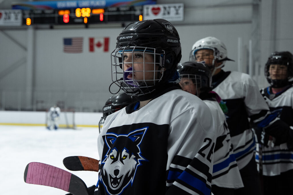 A group of athletes playing football with helmet on the field