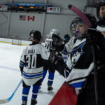 A group of athletes skating with helmet on the rink