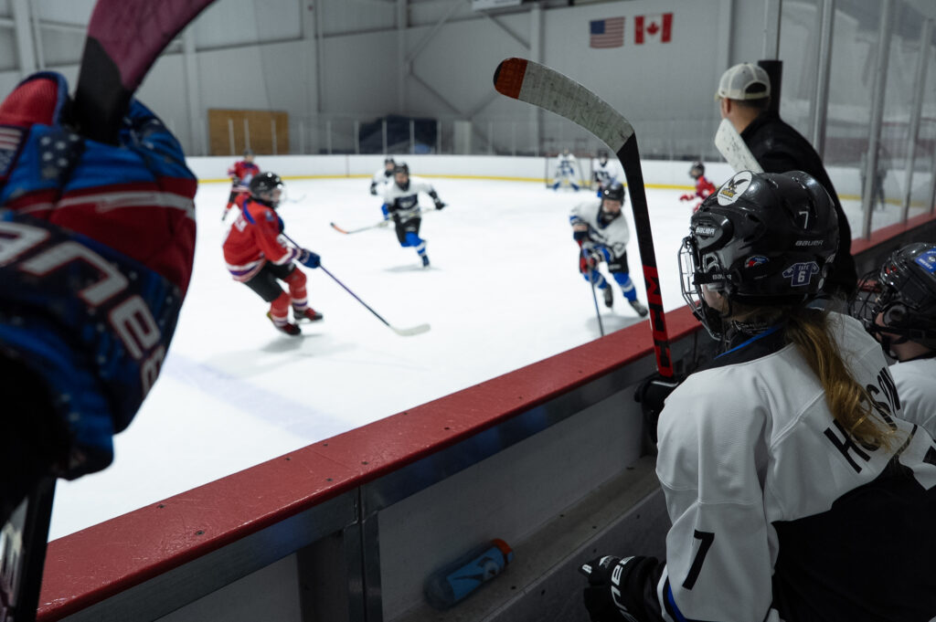 A group of athletes skating with helmet on the rink