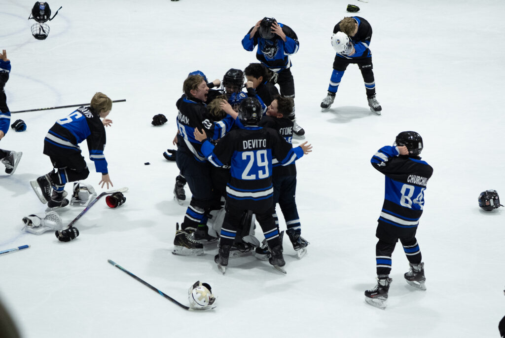 A group of athletes skating with helmet on the rink