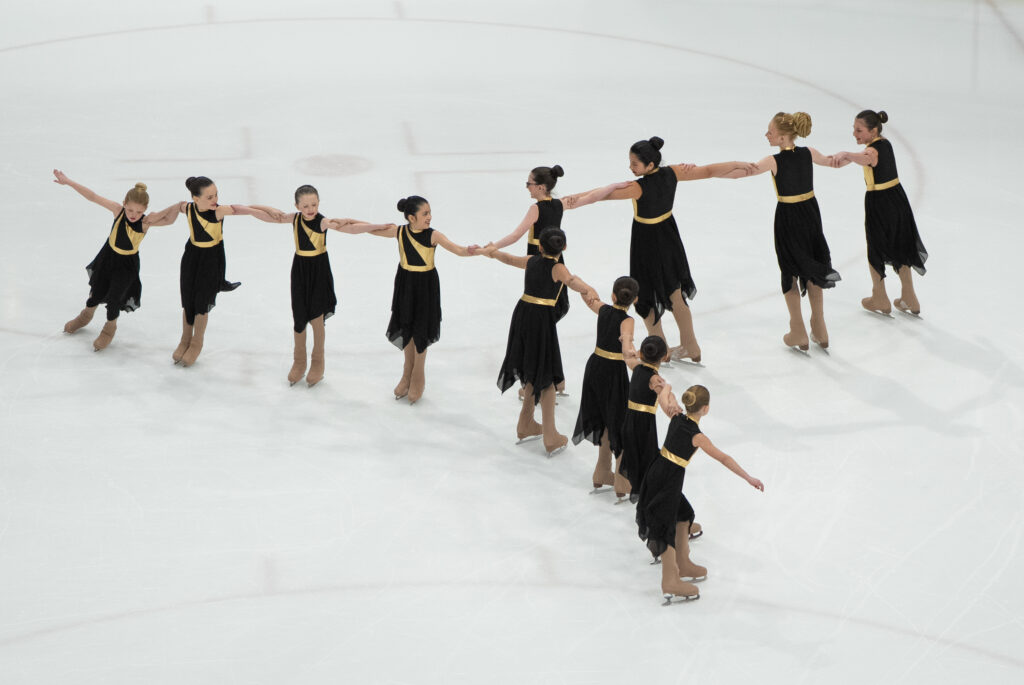 A group of athletes skating on the rink