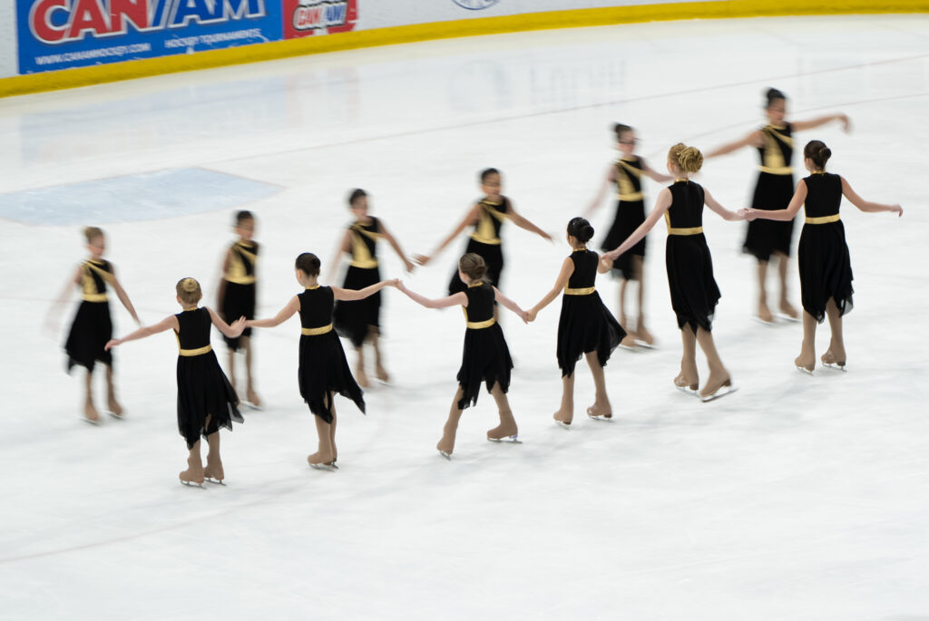 A group of athletes skating on the rink