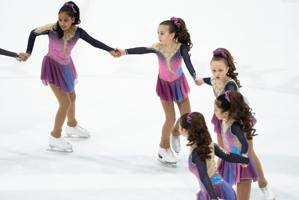 A group of athletes skating on the rink