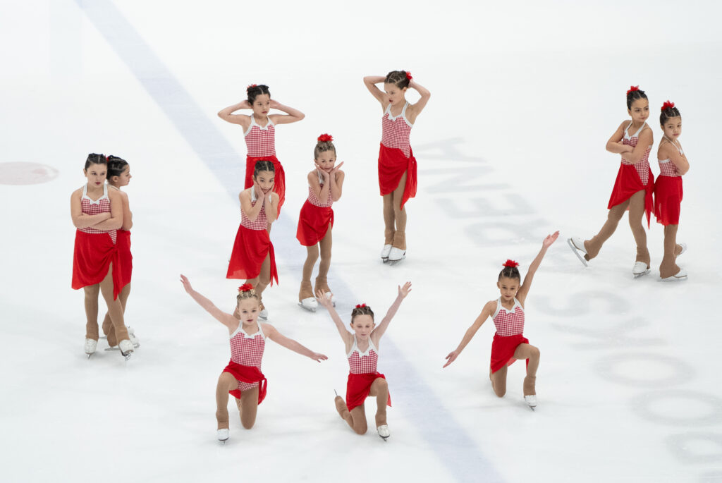 A group of athletes skating on the rink
