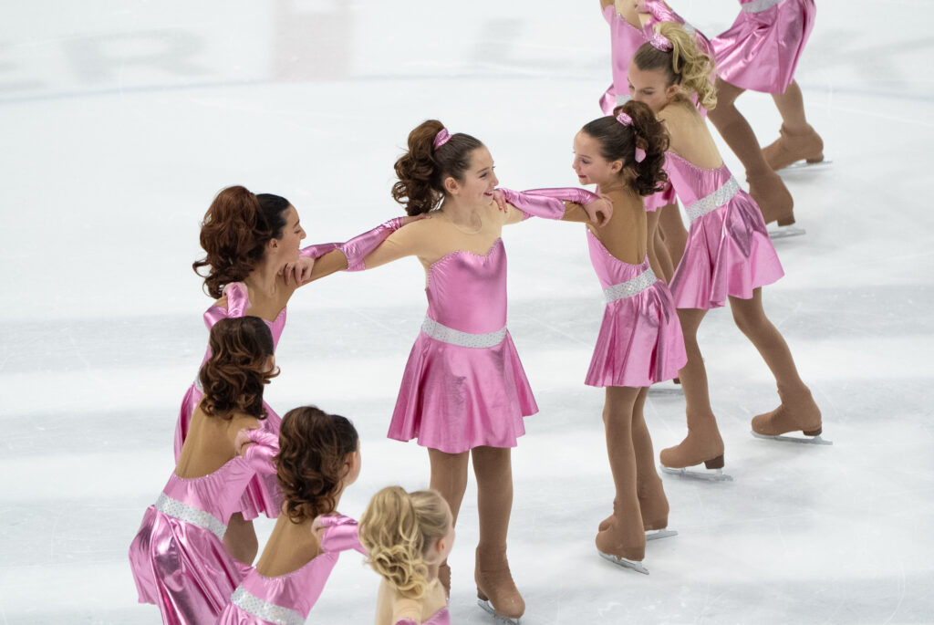 A group of athletes skating on the rink