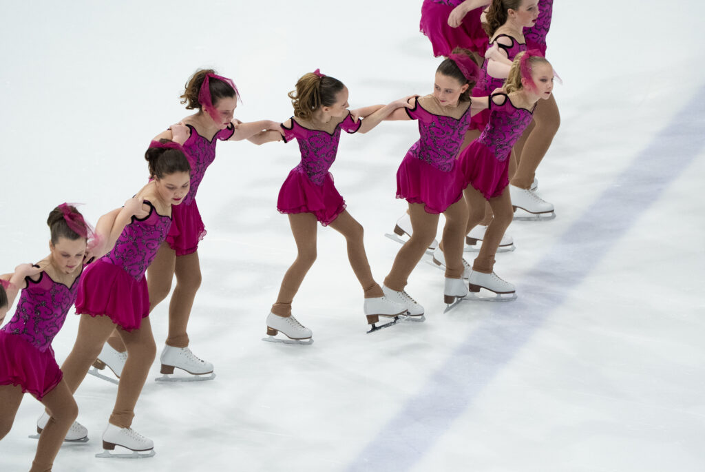 A group of athletes skating on the rink