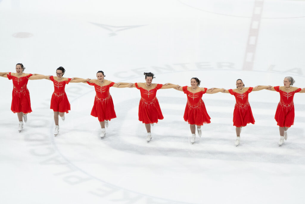 A group of athletes skating on the rink