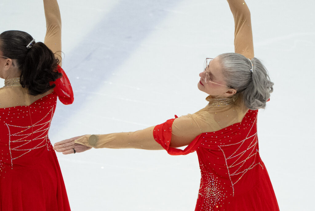 Two athletes skating on the rink