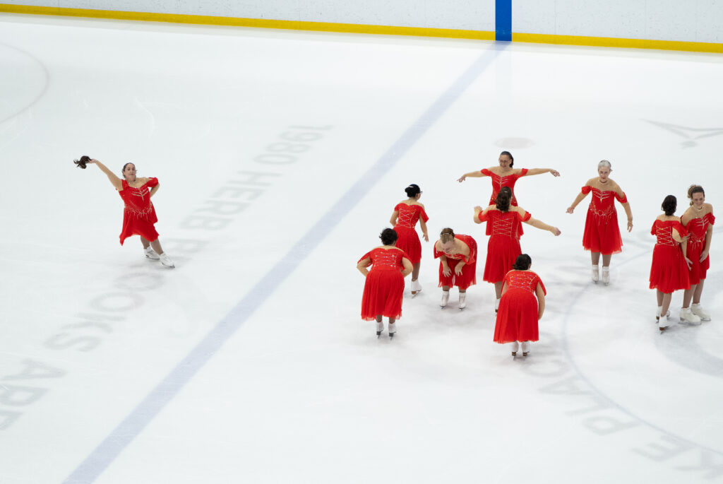 A group of athletes skating on the rink