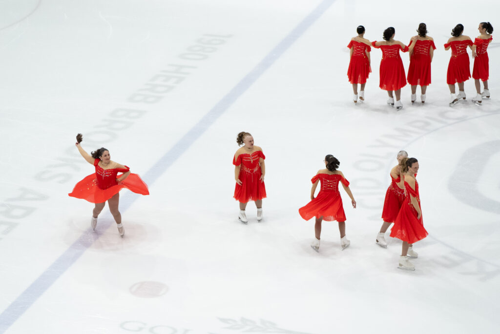 A group of athletes skating on the rink