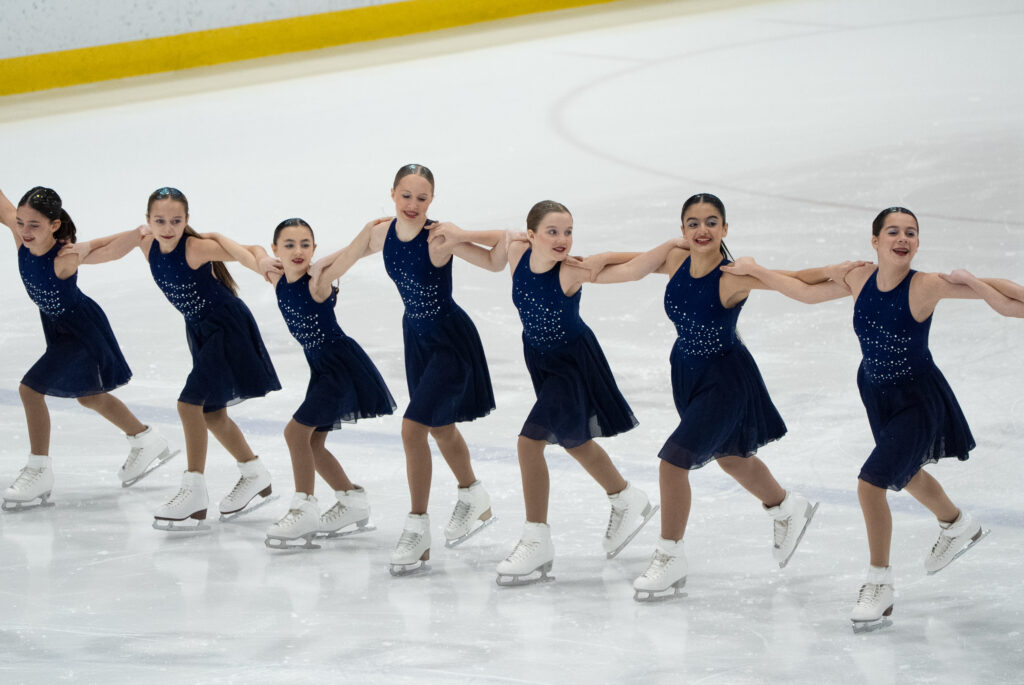 A group of athletes skating on the rink