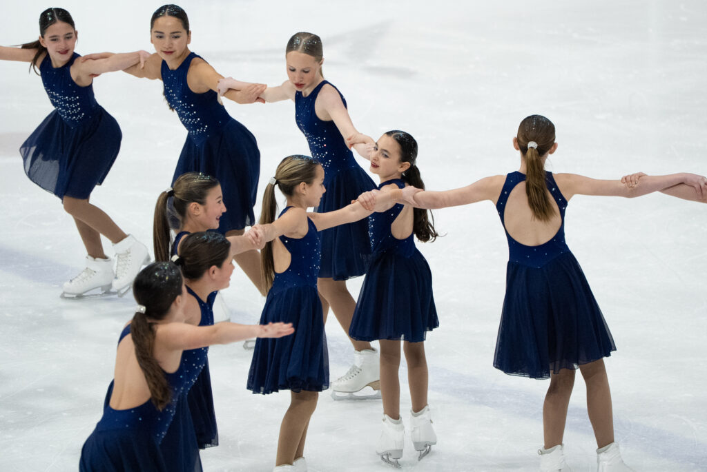 A group of athletes skating on the rink
