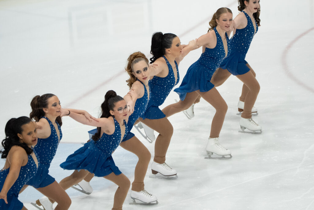 A group of athletes skating on the rink