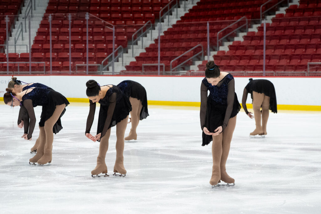 A group of athletes skating on the rink