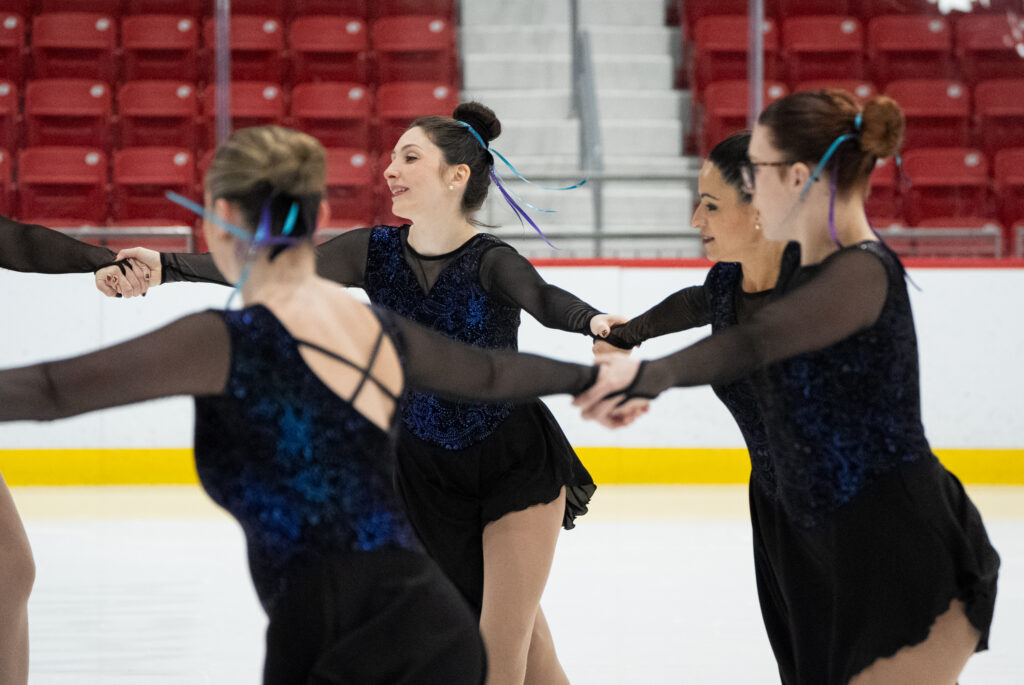 A group of athletes skating on the rink
