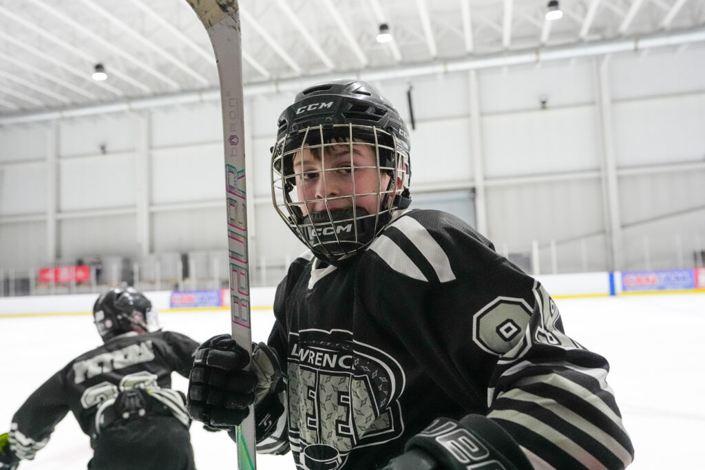 Athletes skating with helmet on the rink