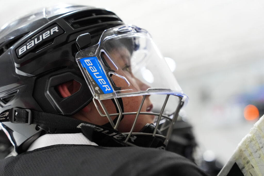 An athlete playing football with helmet on the field