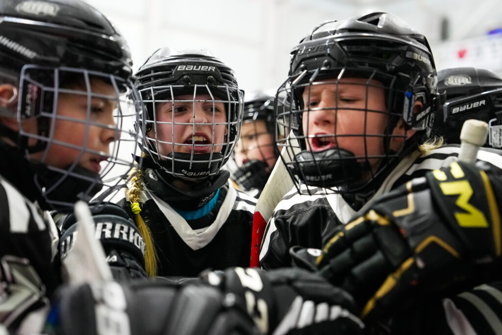 A group of athletes playing football with helmet on the field