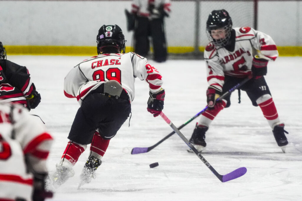 A group of athletes skating with helmet on the rink