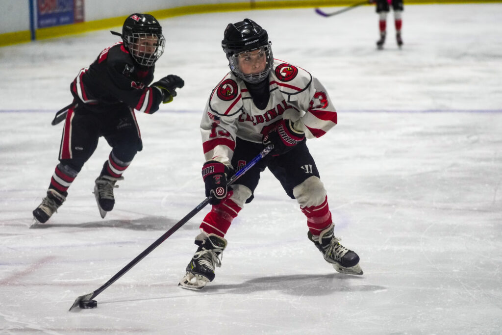A group of athletes skating with helmet on the rink