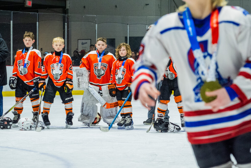 A group of athletes skating with helmet on the rink