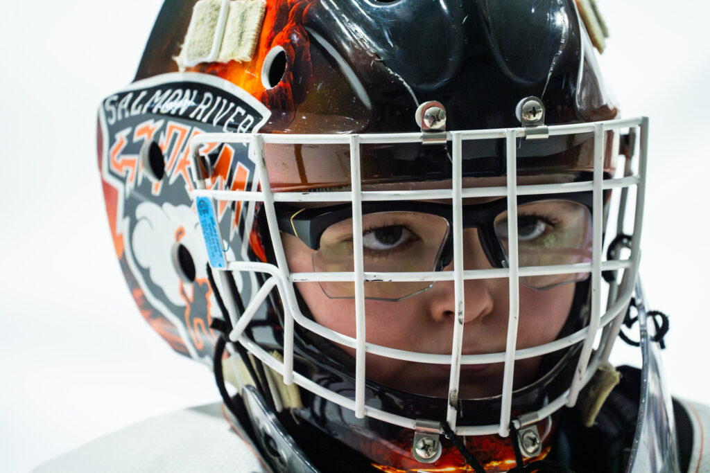 An athlete playing football with helmet on the field