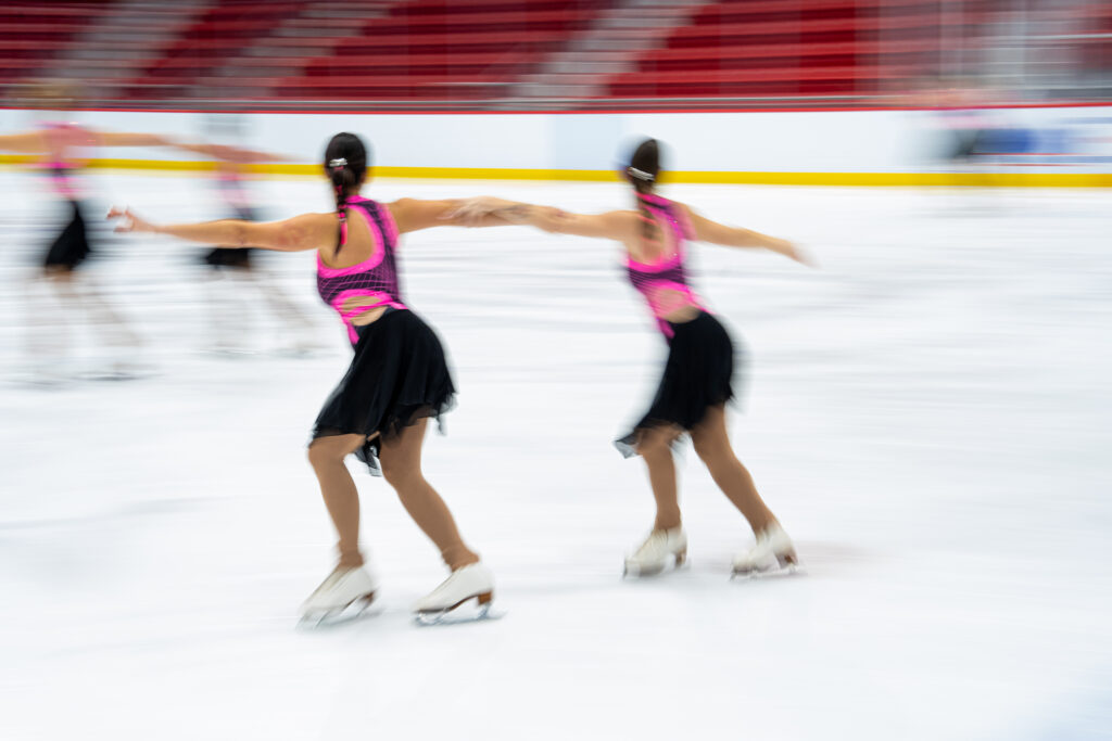 A group of athletes skating on the rink