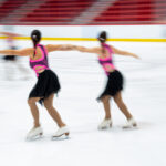 A group of athletes skating on the rink