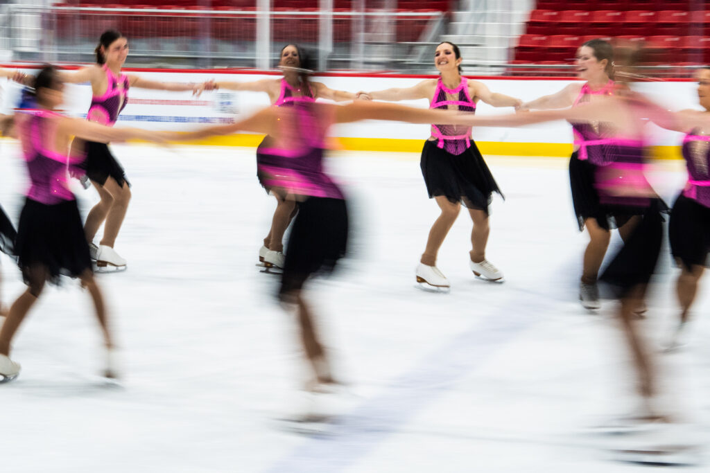 A group of athletes skating on the rink