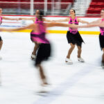 A group of athletes skating on the rink