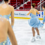 A group of athletes skating on the rink