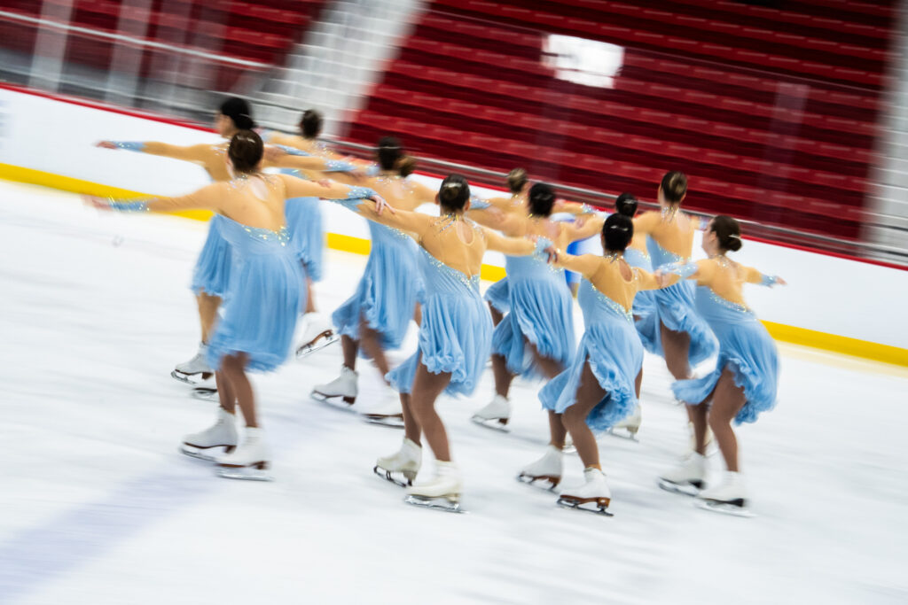 A group of athletes skating on the rink